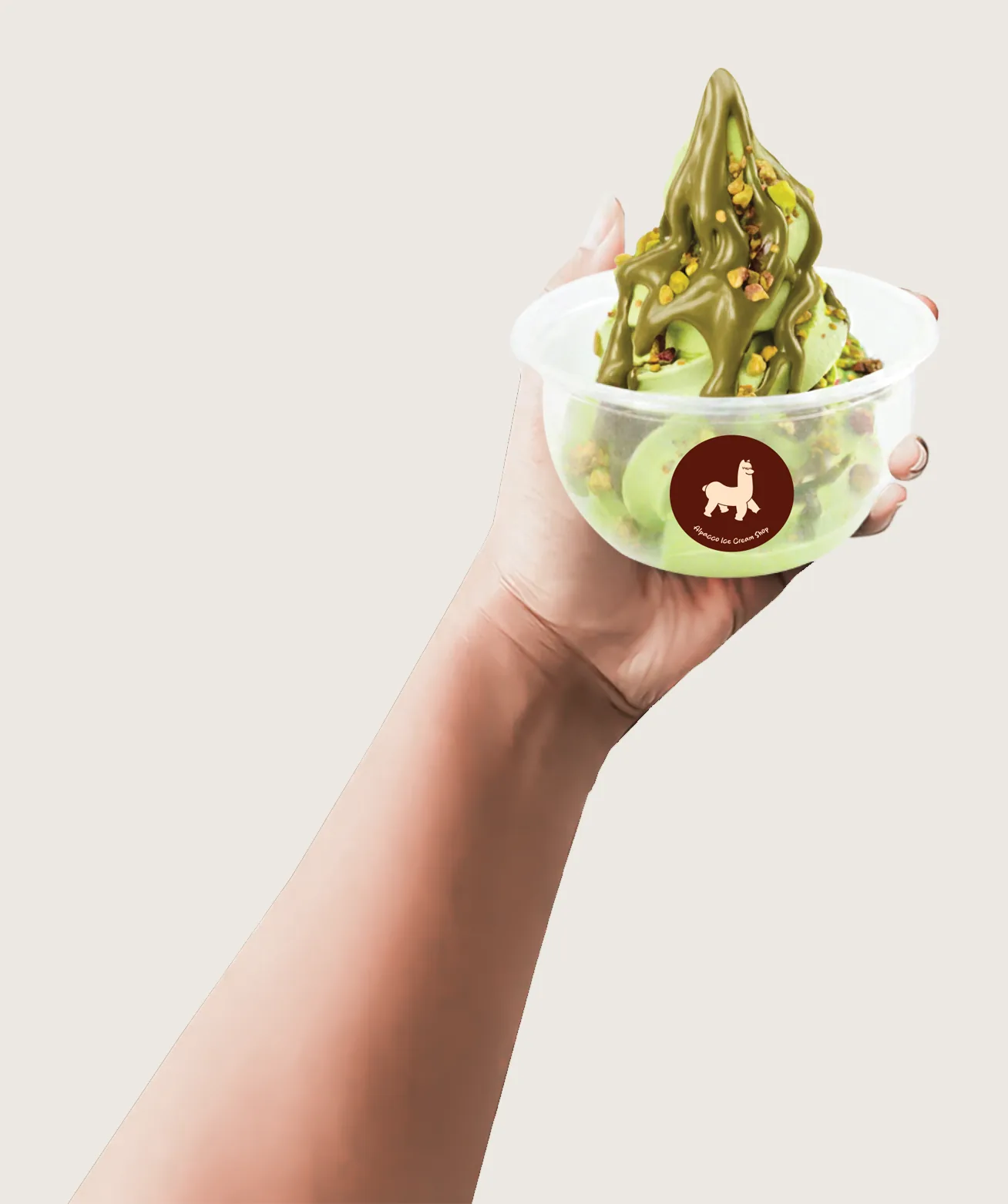 Sundae funday: hand holding up an Alpacco cup of pistachio soft serve