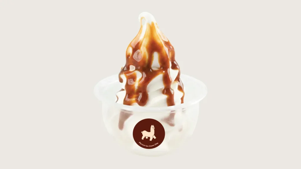 Ice cream toppings malaysia: Alpacco soya soft serve swirl in a cup with brown syrup drizzle