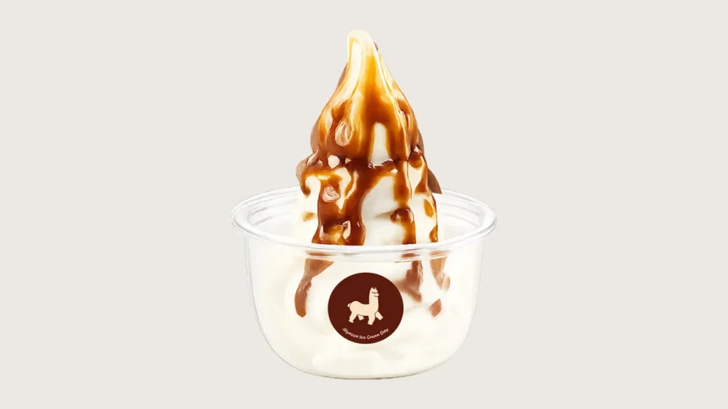 Chewy ice cream toppings: Alpacco soya soft serve in a small cup with brown syrup drizzle